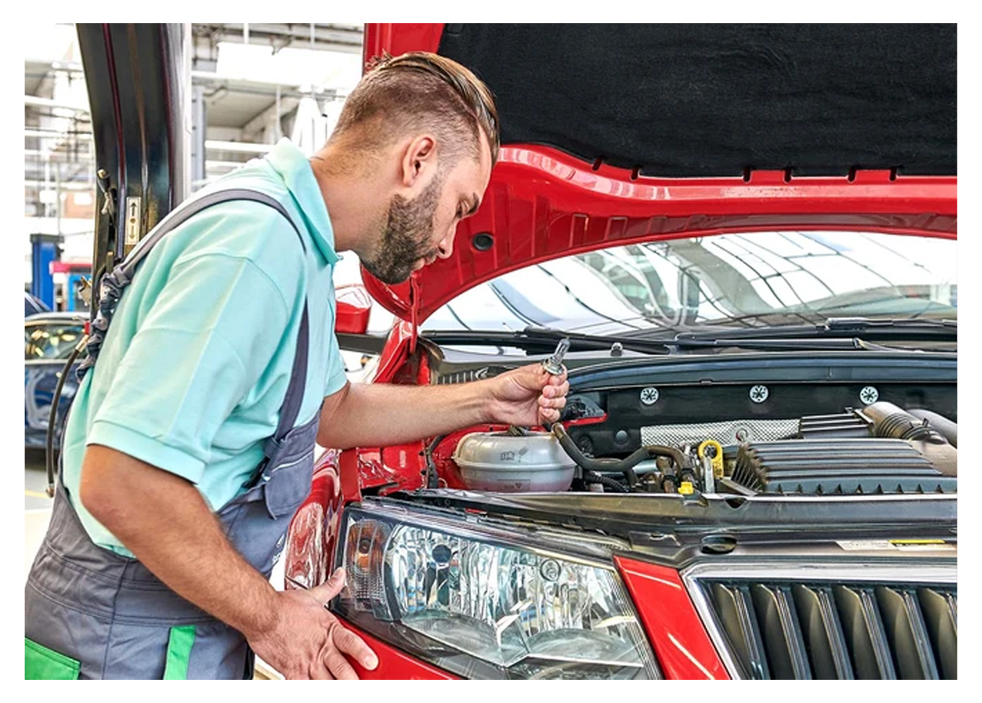 mechanic working on a red Skoda
