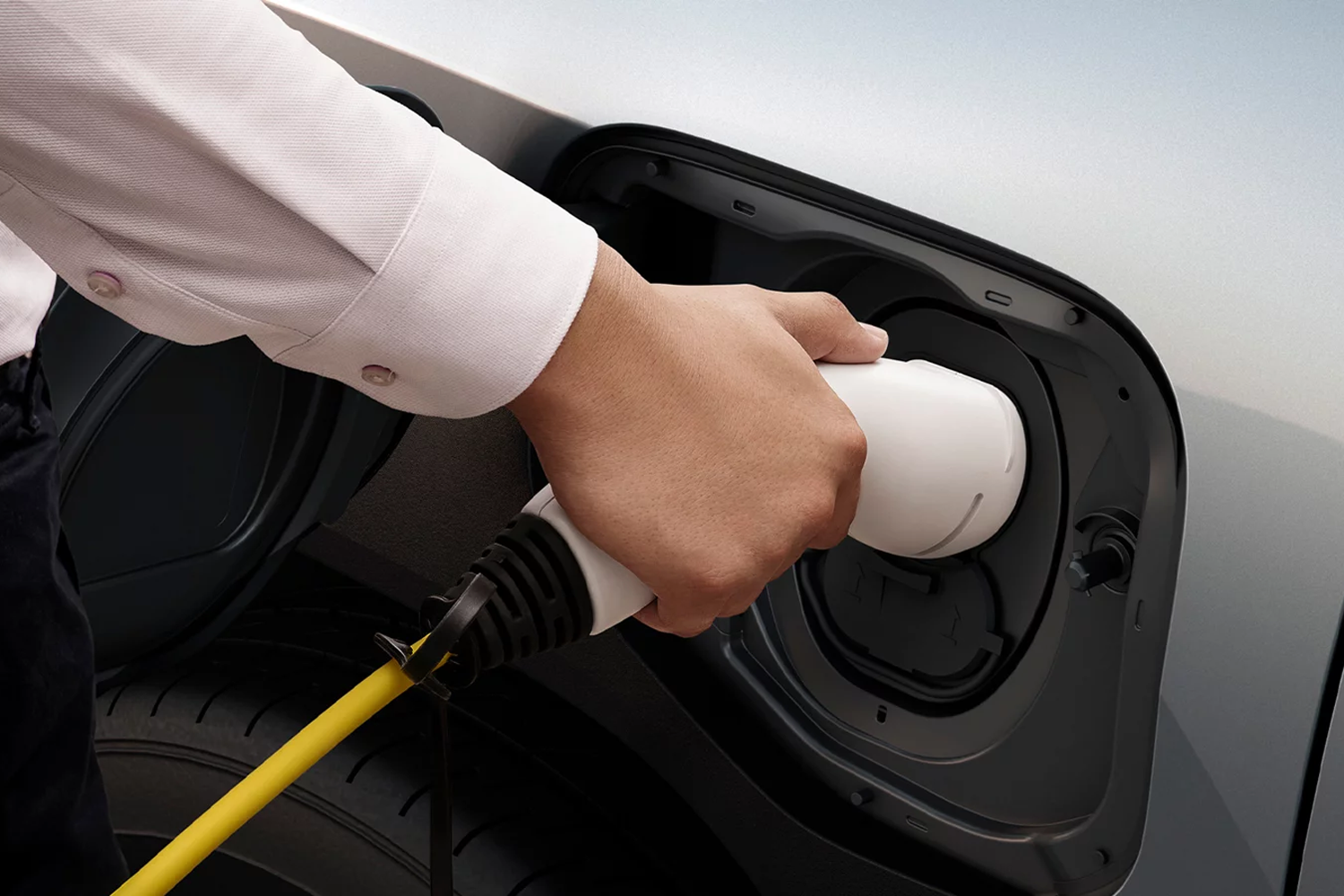 a hand plugging in a car charger