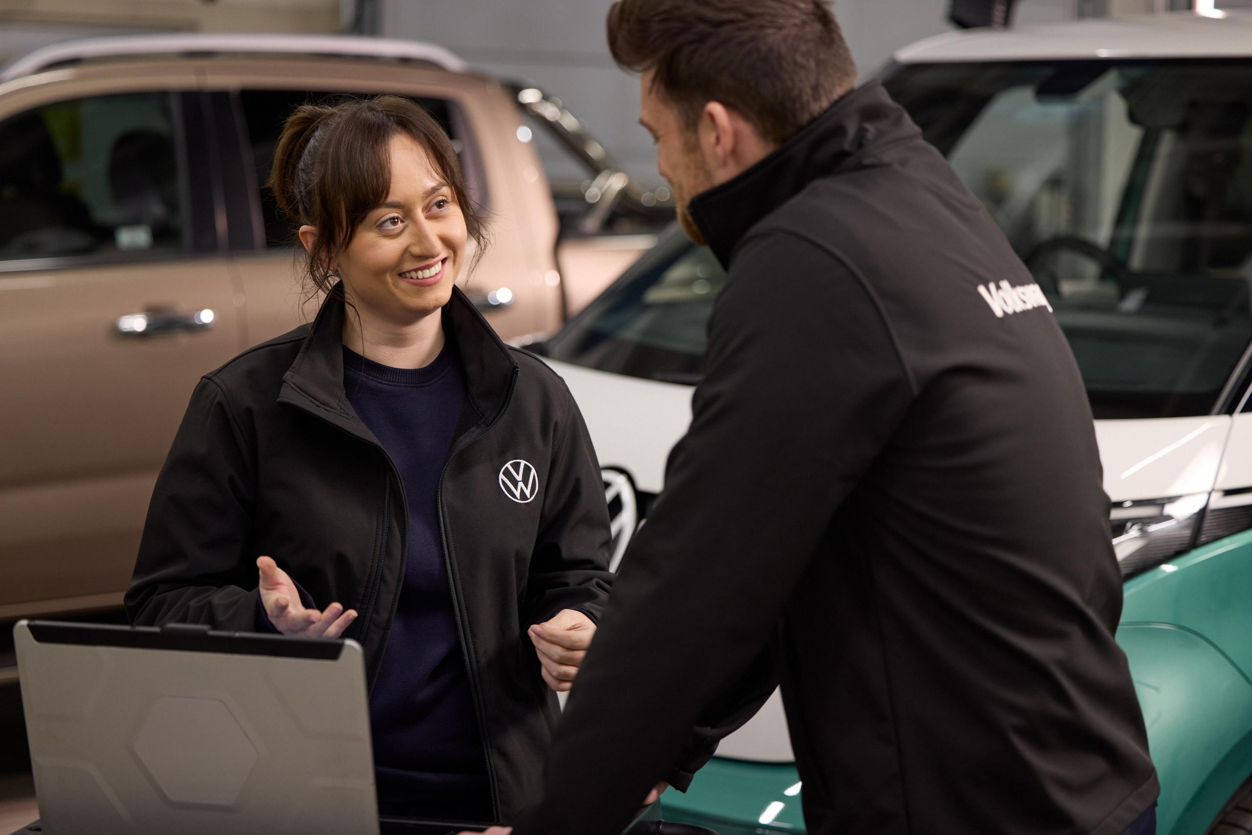 Volkswagen Employees Infront of a laptop