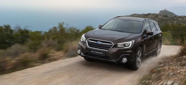 Subaru Outback driving along dirt track