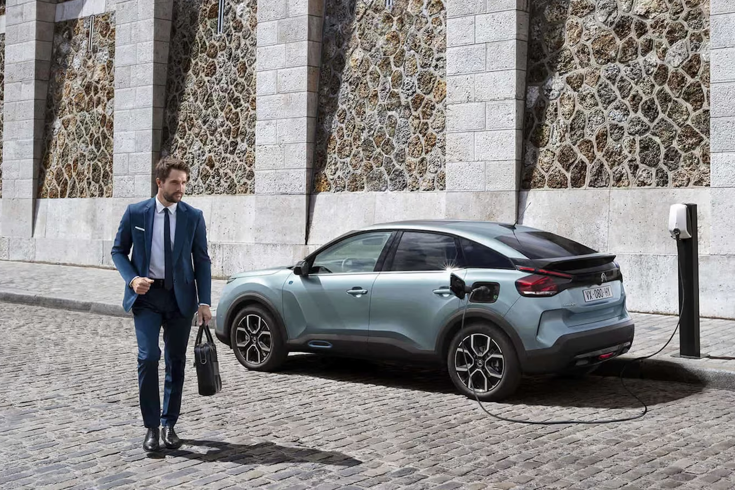 Business man next to Citroen vehicle