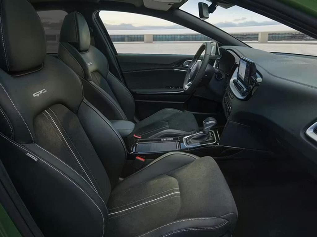 Interior view of the Kia XCeed GT-Line, featuring sculpted sports seats with contrast stitching, dark upholstery, central touchscreen and modern dashboard layout.