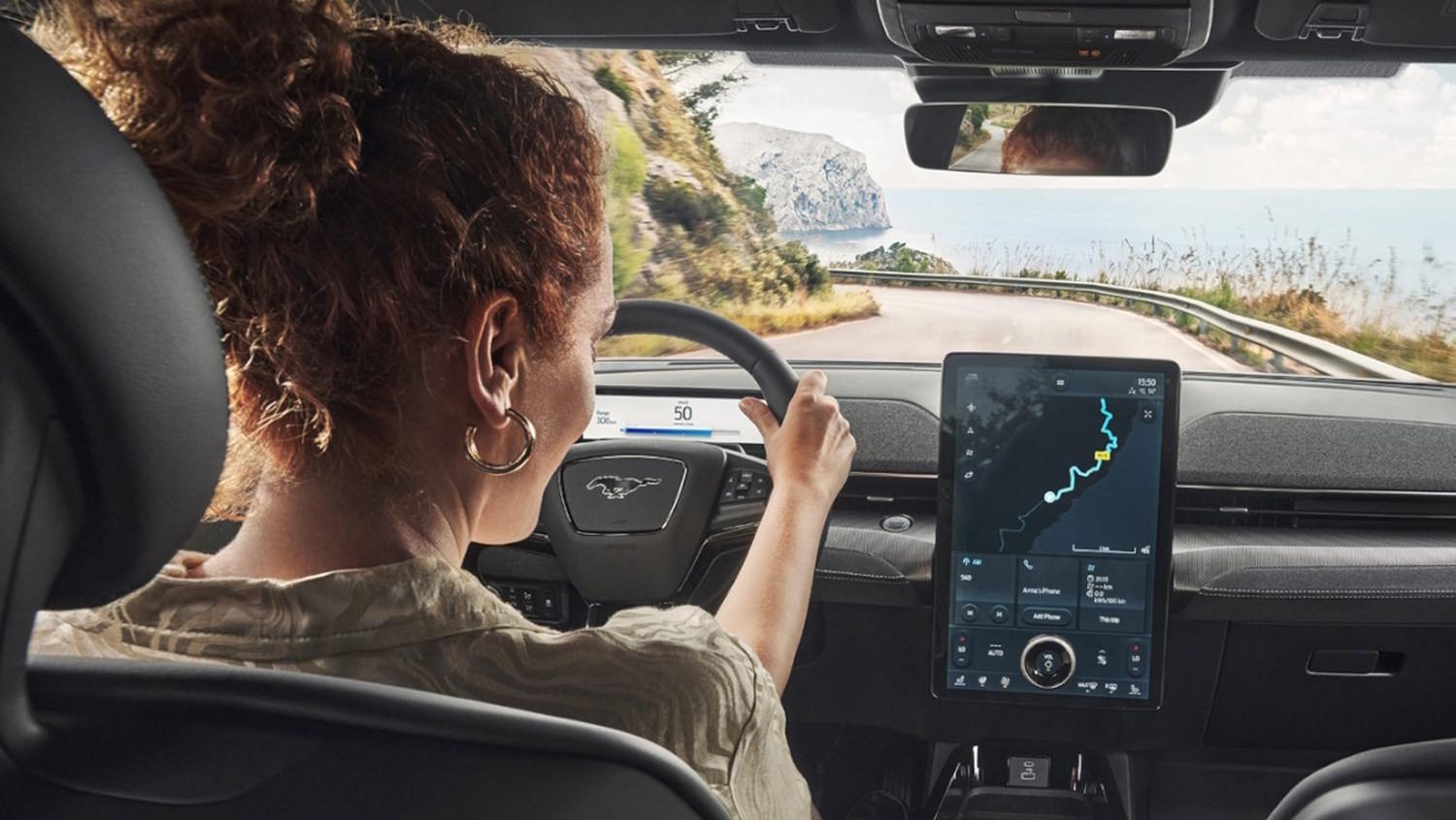women inside a ford Mach E looking at the infotainment