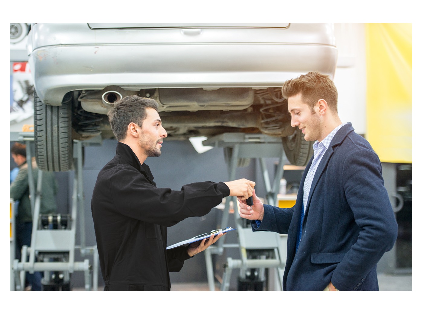 mechanic handing over keys to a customer