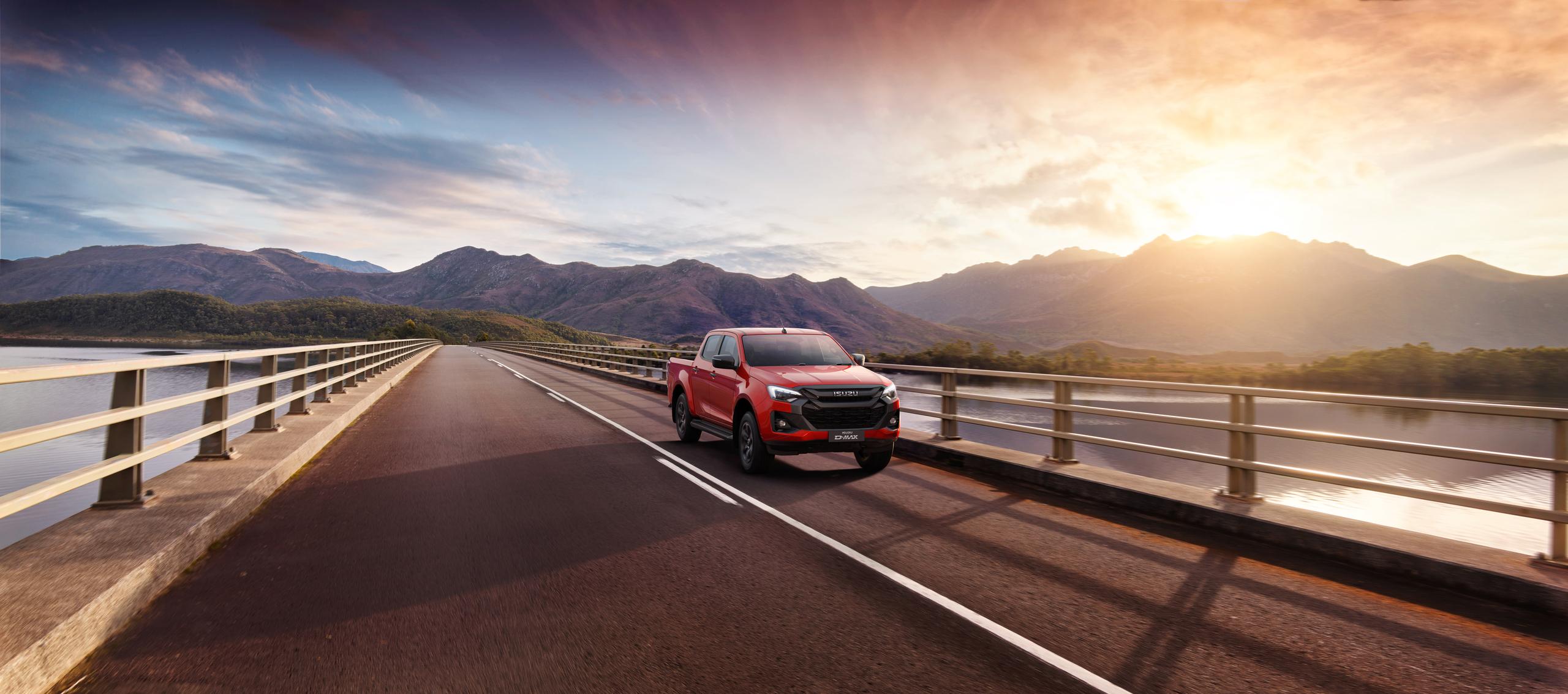 red isuzu V-Cross on the bridge