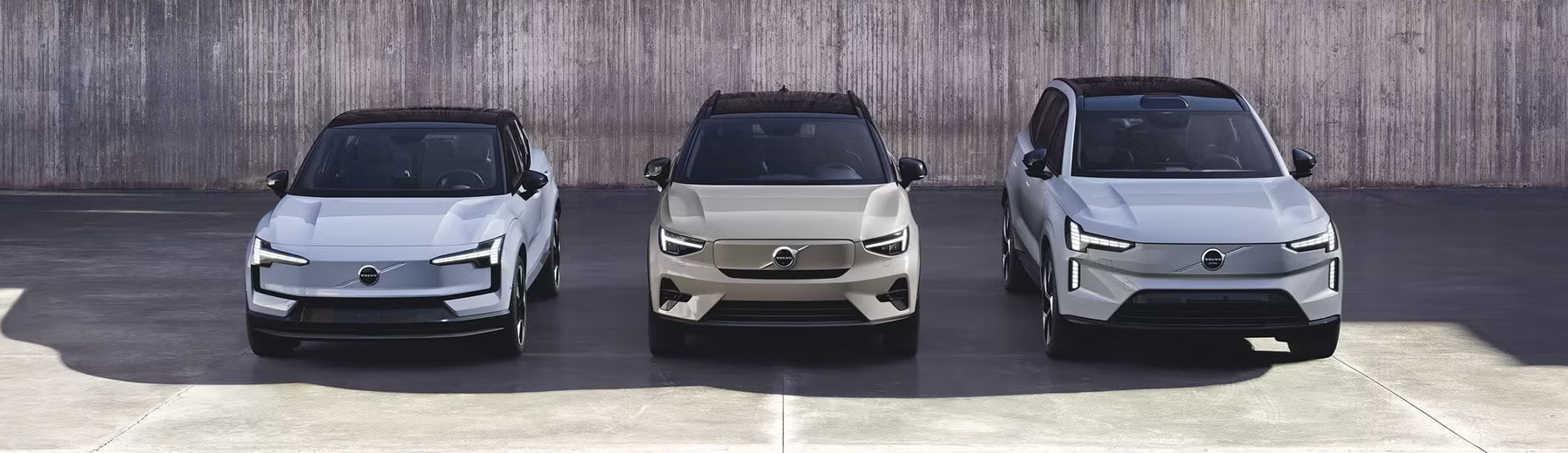 Lineup of Volvo cars parked outdoors.
