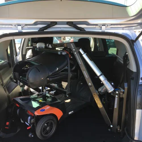 Motability Scooter folded away in the back of a car.