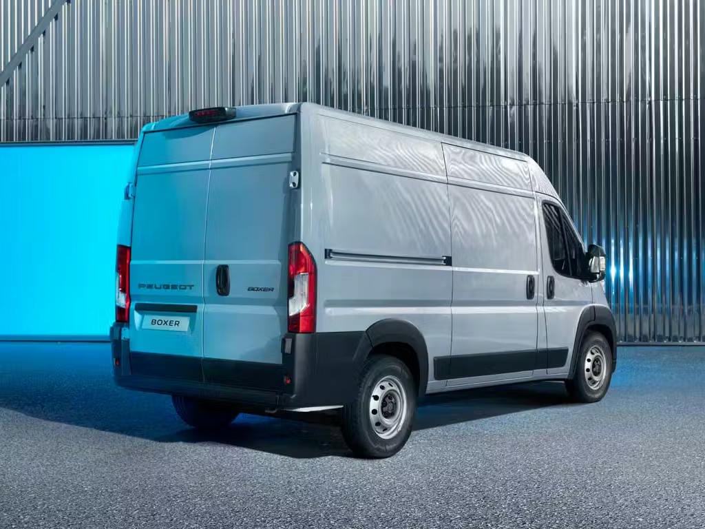 Peugeot Boxer panel van shown from the rear three-quarter angle in a professional industrial setting.