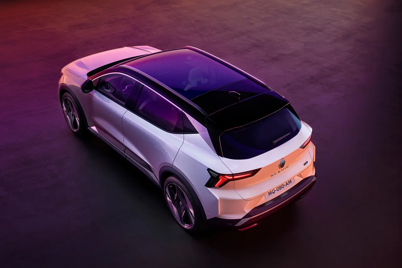 White Renault Scenic E-Tech on pink background aerial view