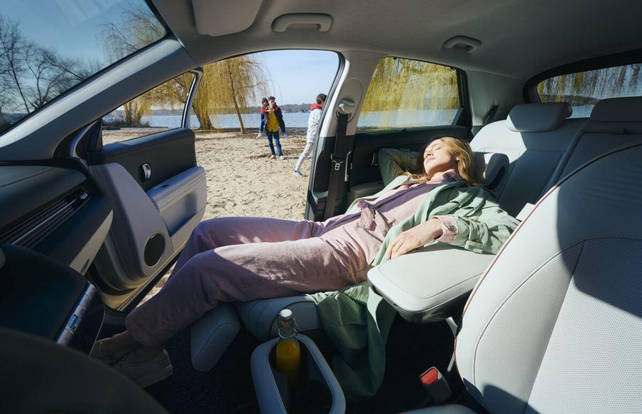 Person lying down in front seat in the Hyundai IONIQ 5