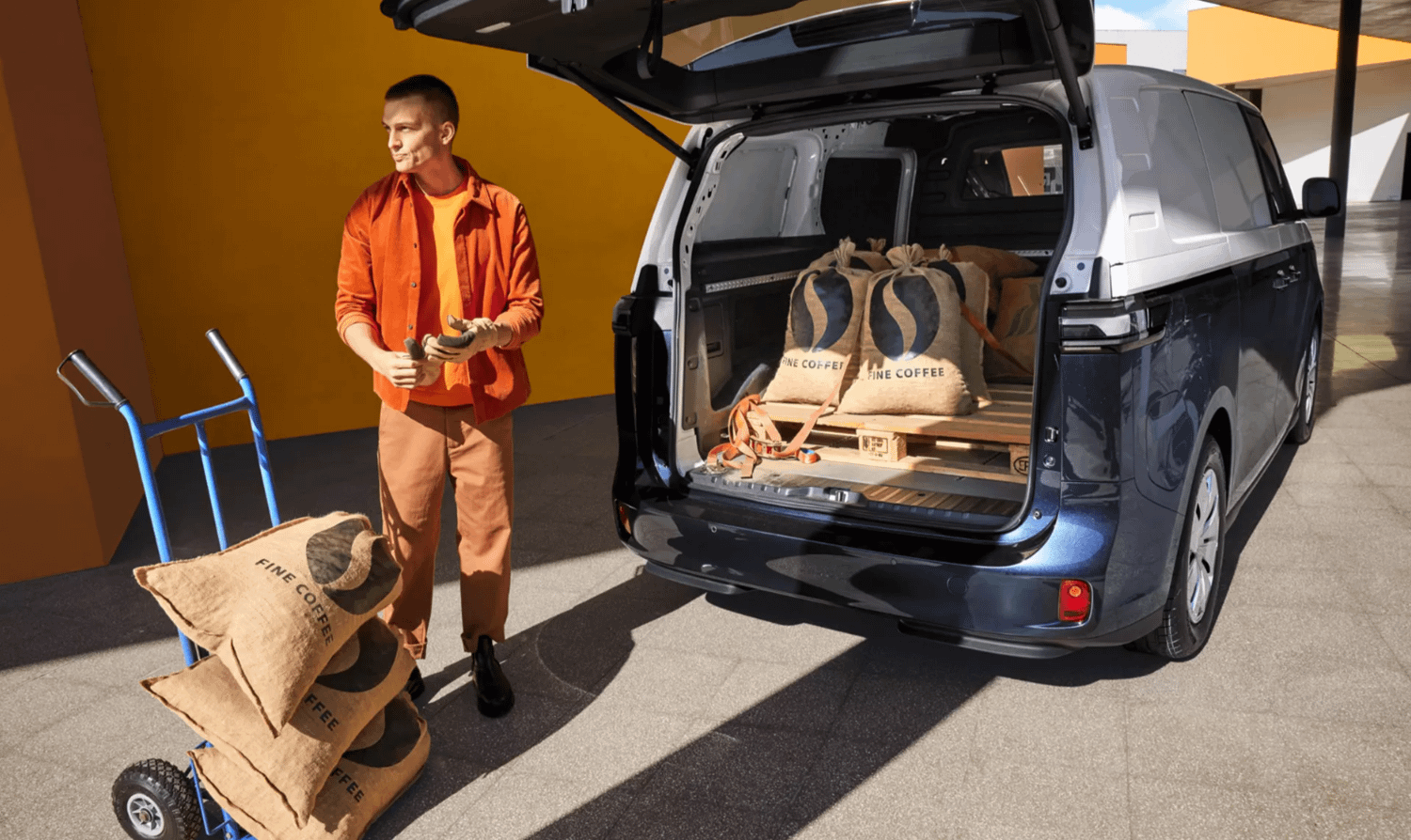 Person loading cargo into Volkswagen ID. Buzz Cargo boot