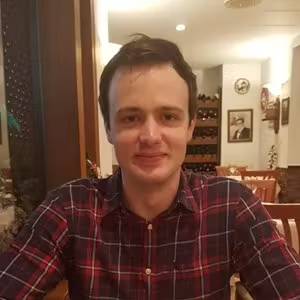 Indoor portrait of a person sitting in a restaurant or café environment.