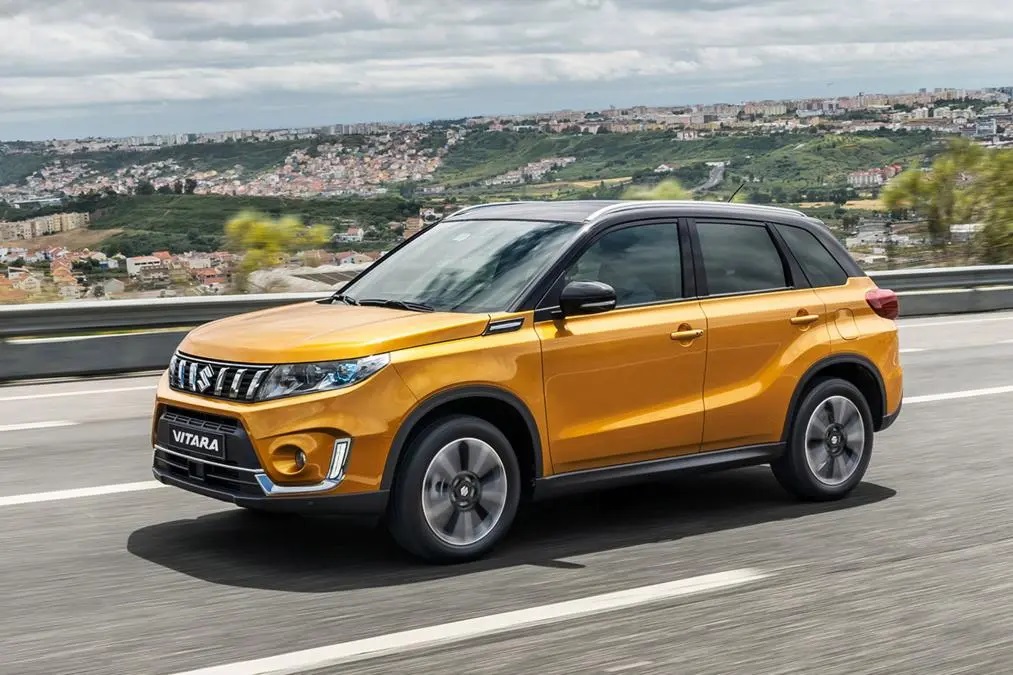 Orange Suzuki Vitara driving along road