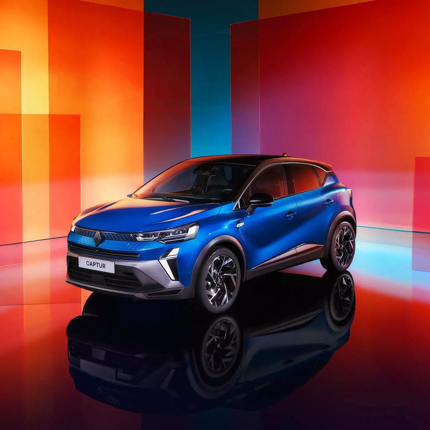 Exterior view of a blue Renault Captur with a glossy finish, front and side profile.