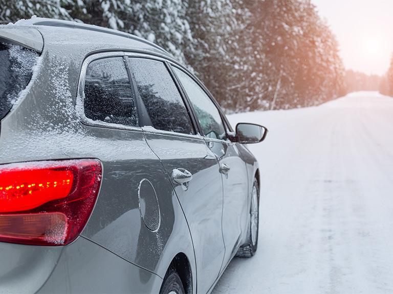 grey estate car driving in snowy conditions
