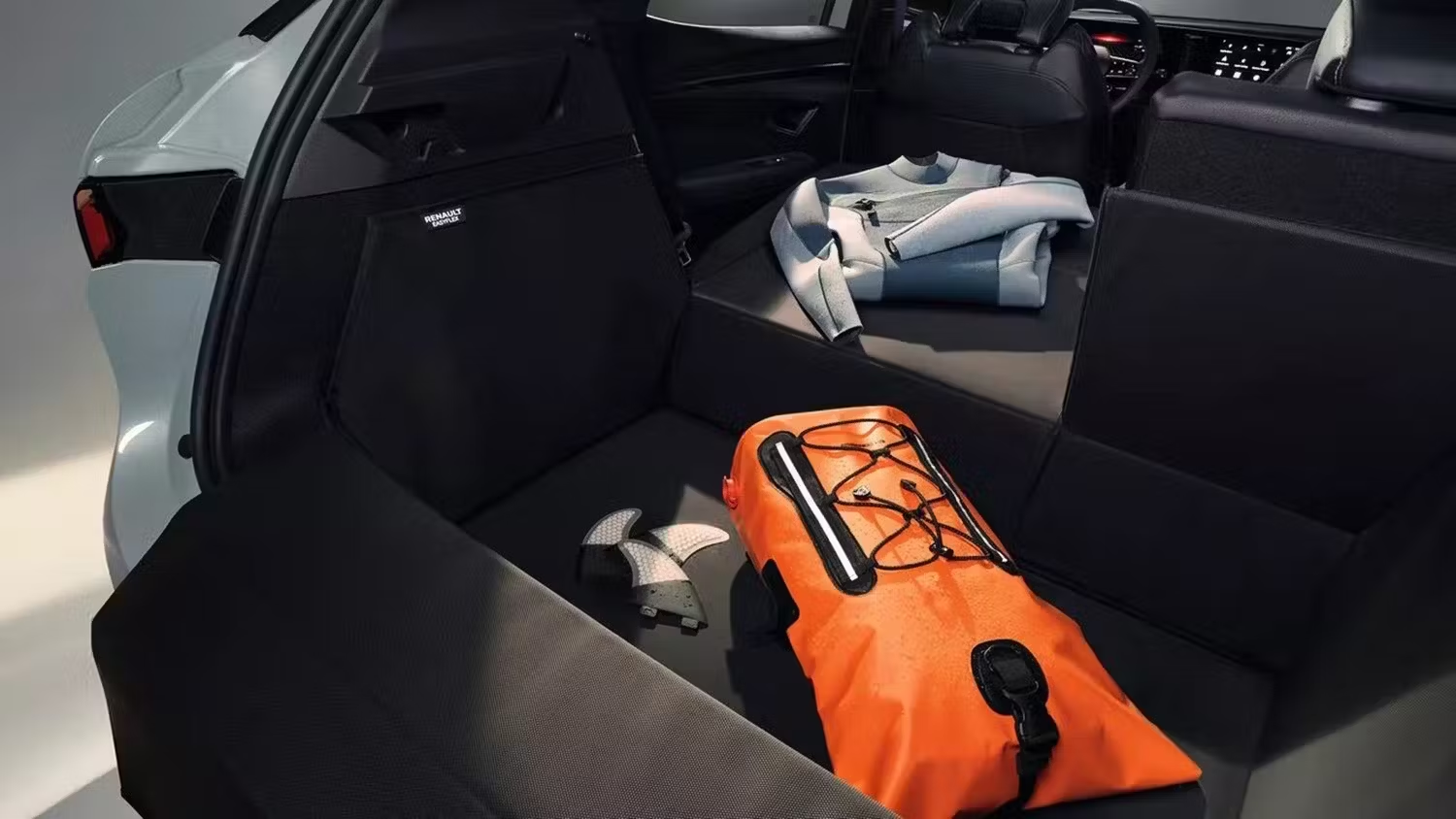 Renault vehicle boot space with rear seats folded, showing luggage and storage capacity.