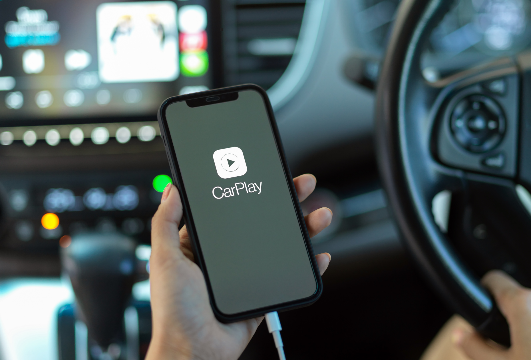 Apple Carplay in car, phone with play symbol