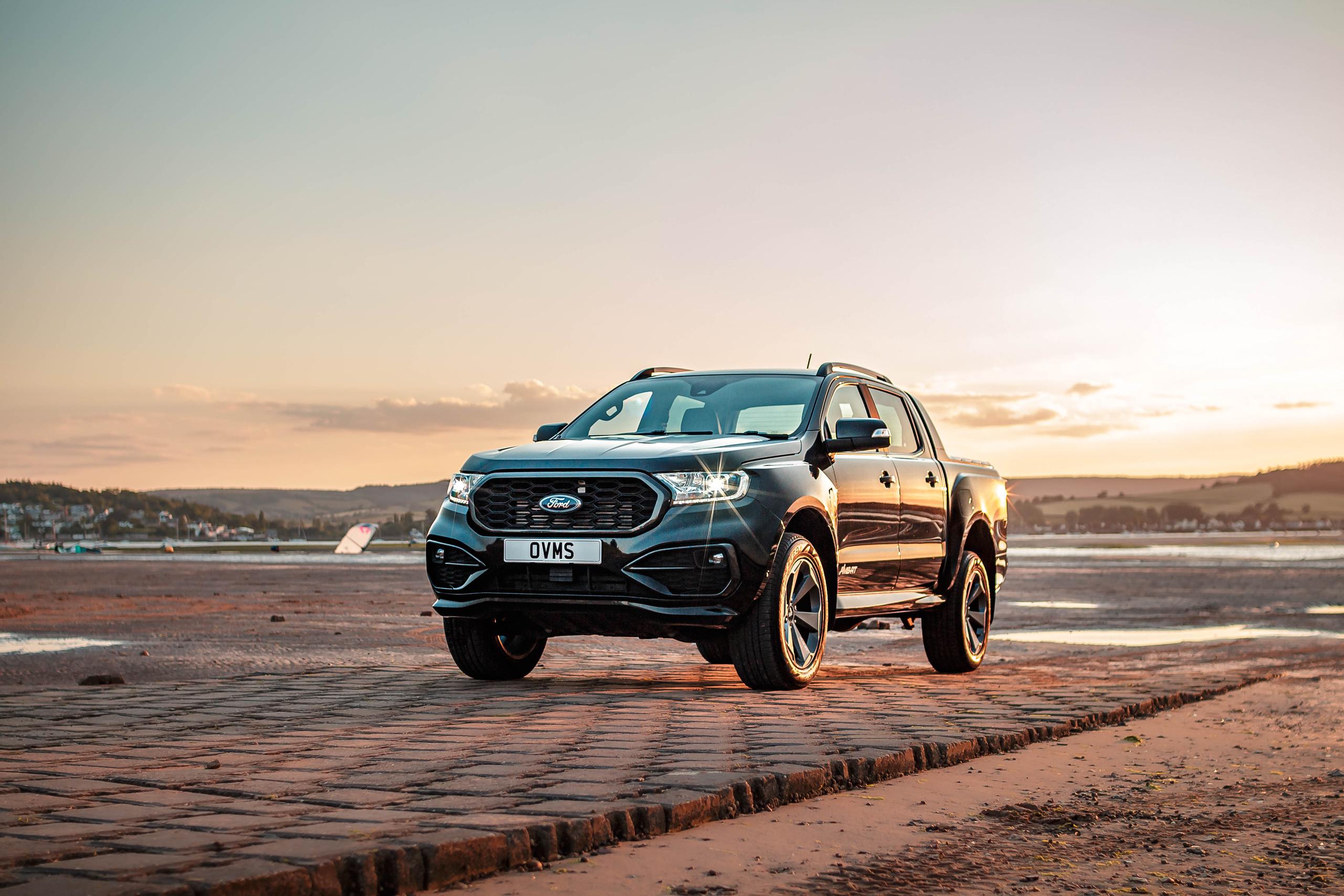 Dark Ford Ranger parked on airstrip with golden-hour backdrop