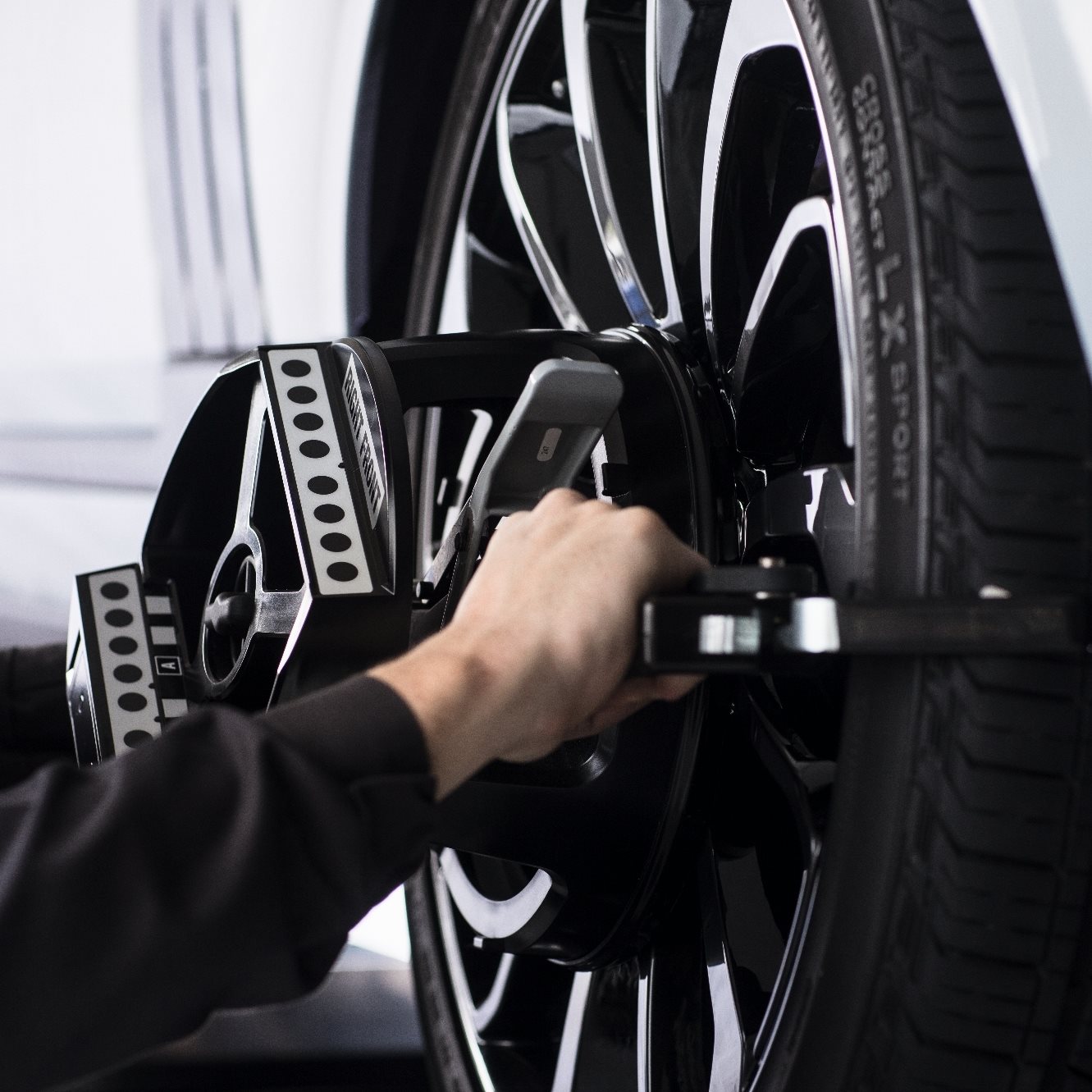 Mechanic aligning wheel