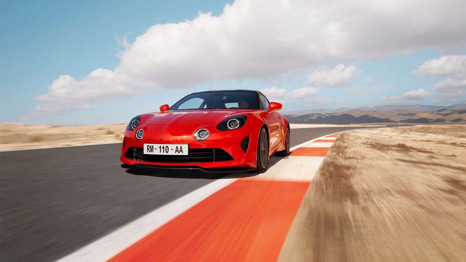 red Alpine A110S driving on road from front