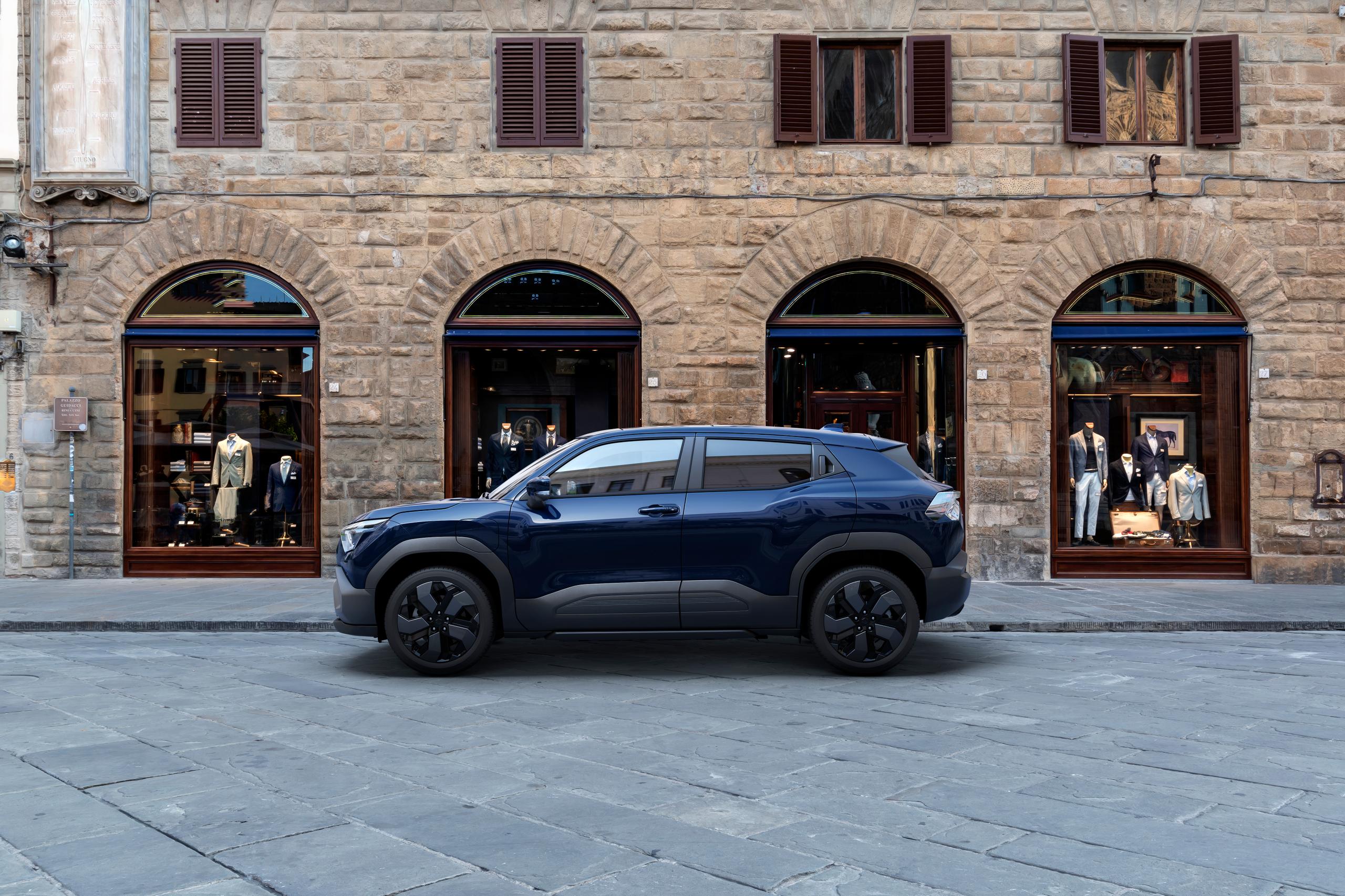 Suzuki e-vitara parked by a store