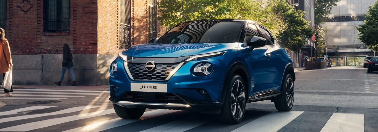 Blue Nissan Juke driving down street