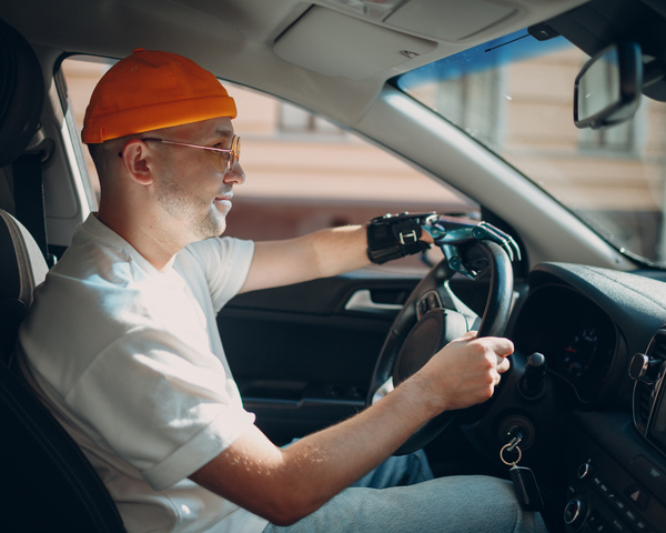 Man driving car with hands on steering wheel