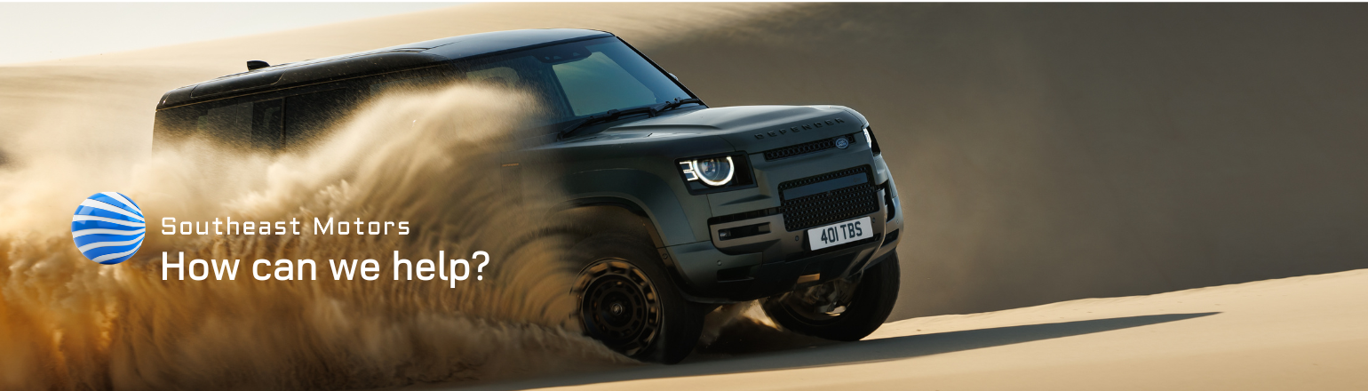 Defender off-road in desert with Southeast Motors message.