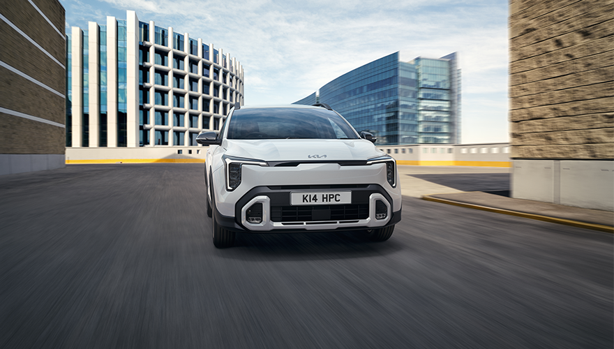 New Kia Stonic driving through city landscape