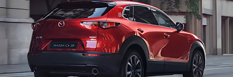 Mazda CX-30 in red exterior rear side view