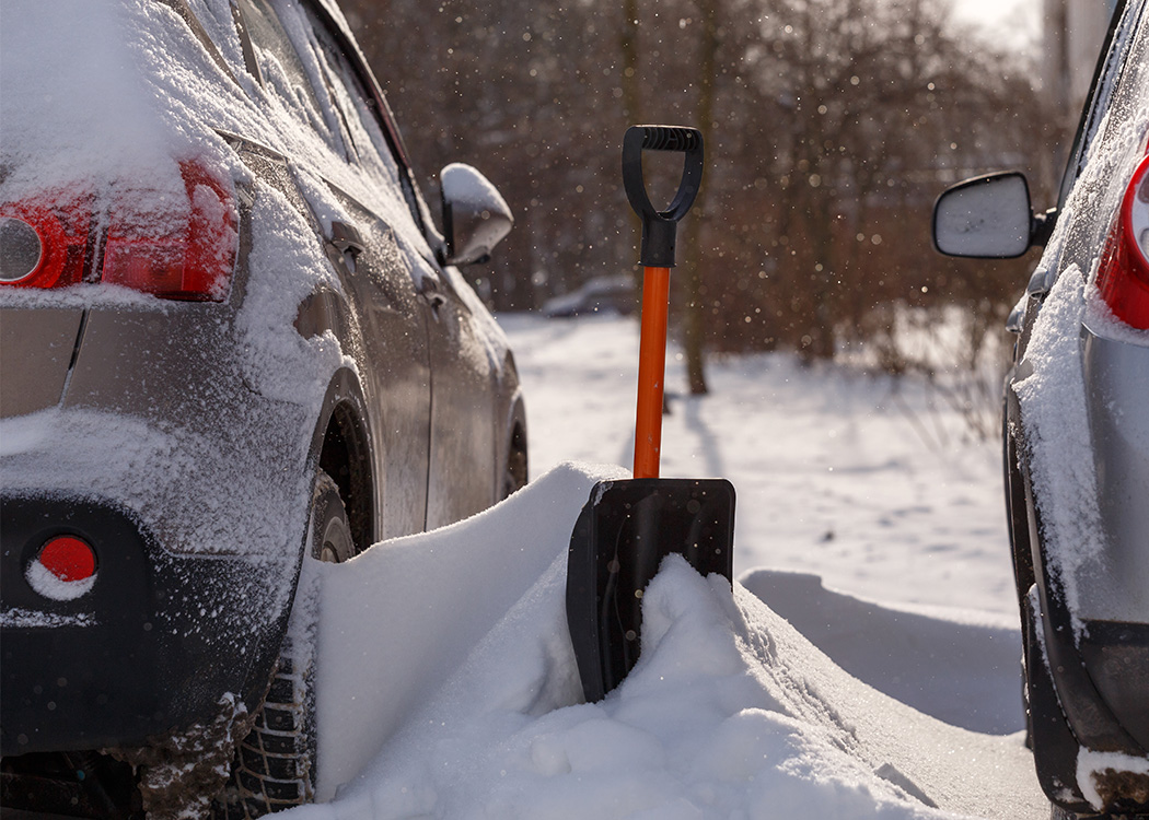 shovel snow beside car