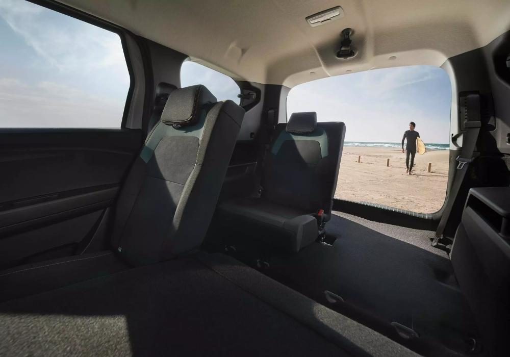 Dacia Jogger interior rear seating area viewed from the boot, showing flexible space with beach visible outside.