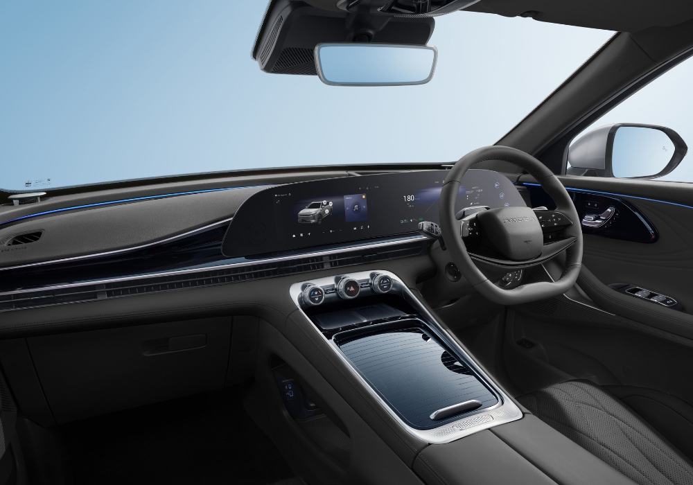 OMODA 9 interior featuring a wide curved digital display, ambient lighting, and a clean center console design.