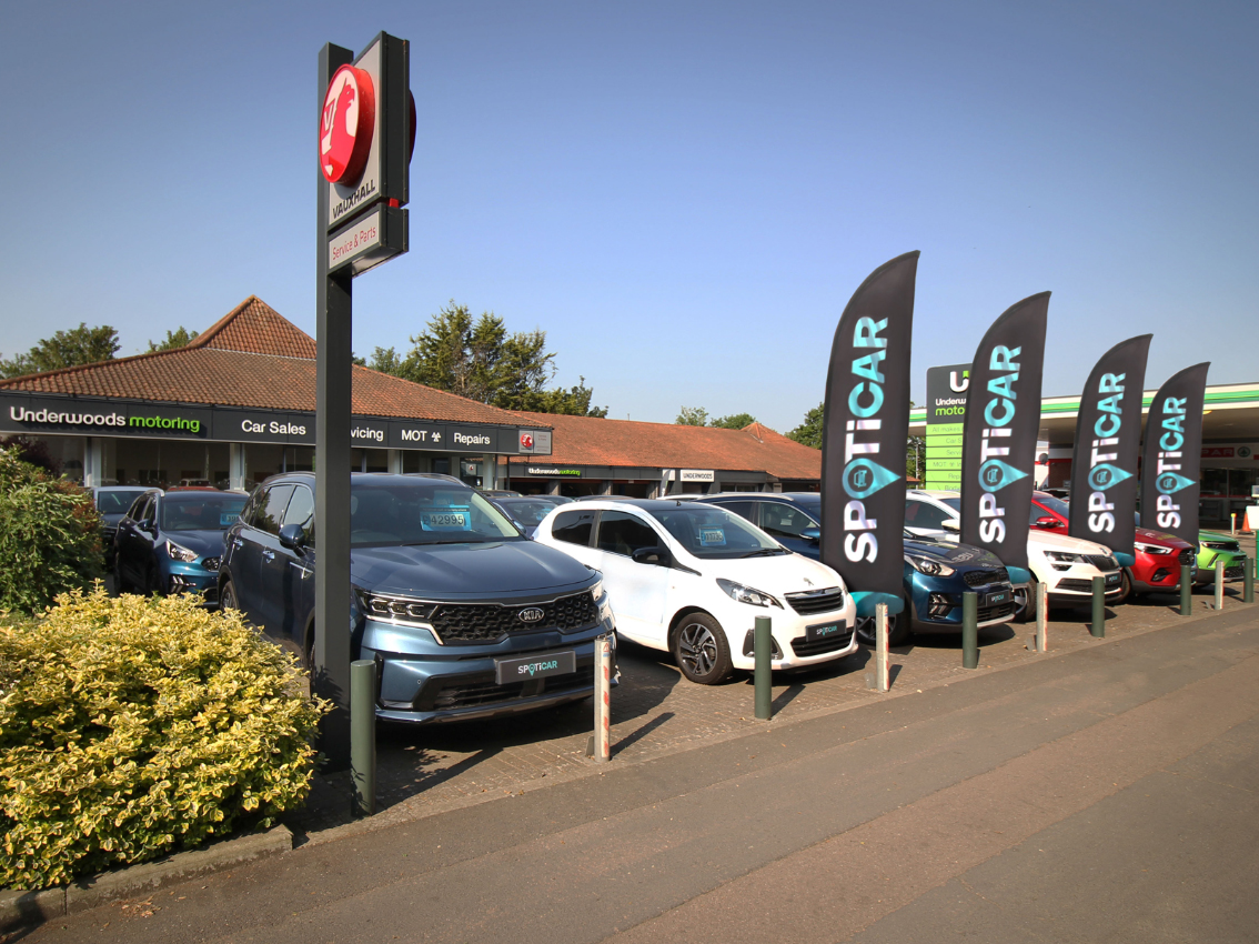 Exterior view of the Underwoods Motoring dealership with used cars on display.