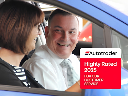 Happy customer with a dealership sales advisor recognised for excellent customer service.