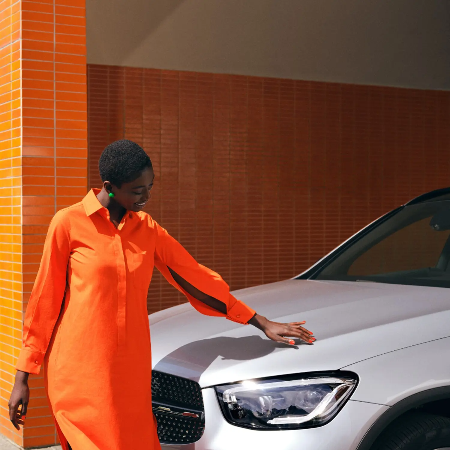 Person with hand on Mercedes-Benz Vehicle