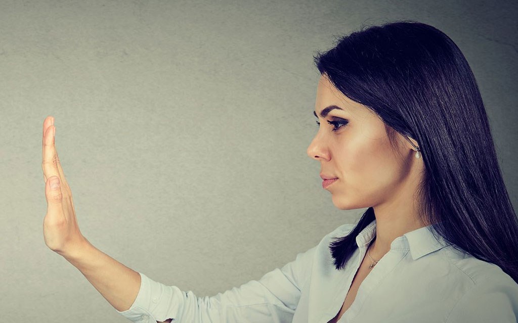 Woman with hand up side view