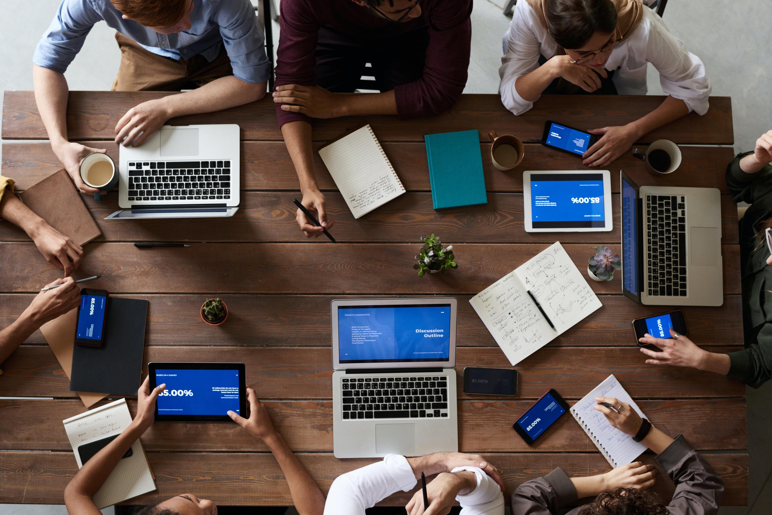 People working round a desk birds eye view