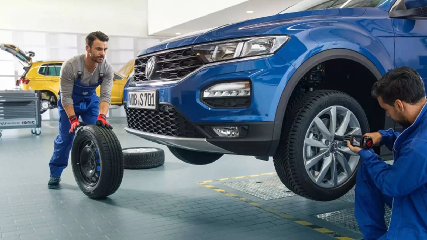 Mechanics Working ON VW Vehicle
