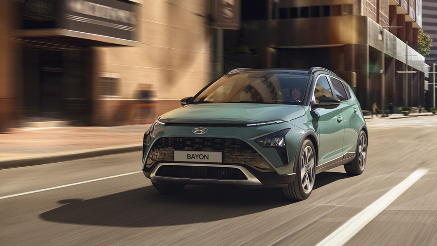 Green Hyundai Bayon driving
