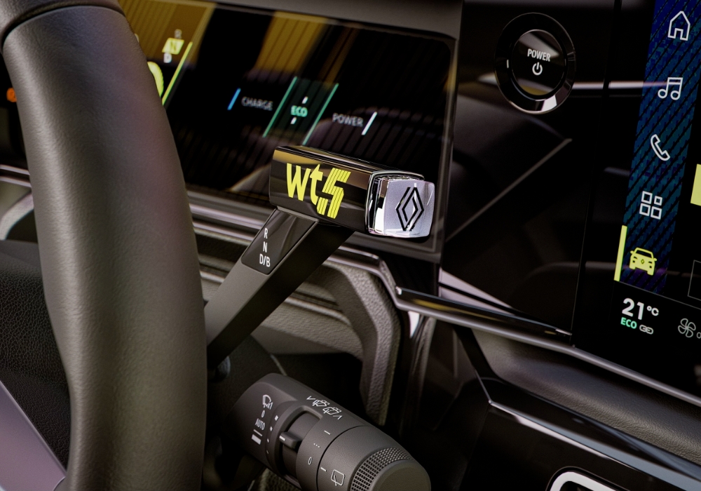 Renault 5 E-Tech interior detail showing gear selector and digital display controls.