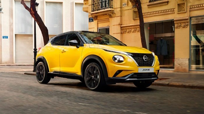 A yellow new Nissan Juke on a city street