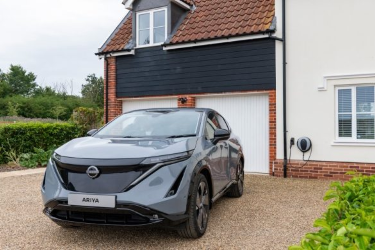 Nissan ARIYA parked on drive outside house