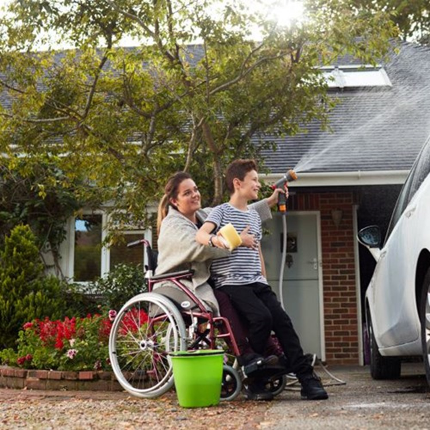 Mother and son washing car