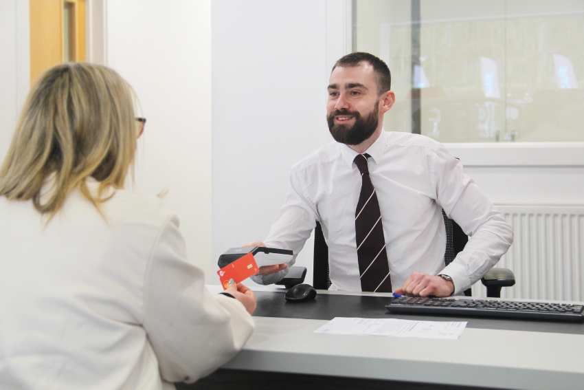 Underwoods Motoring adviser completing a vehicle key handover.