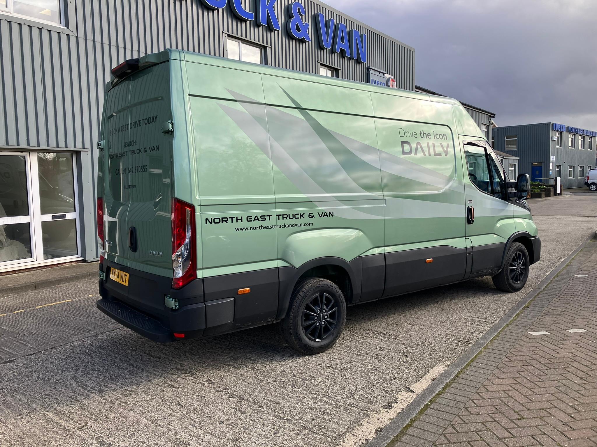 Green Iveco truck parked in front of north east truck and van