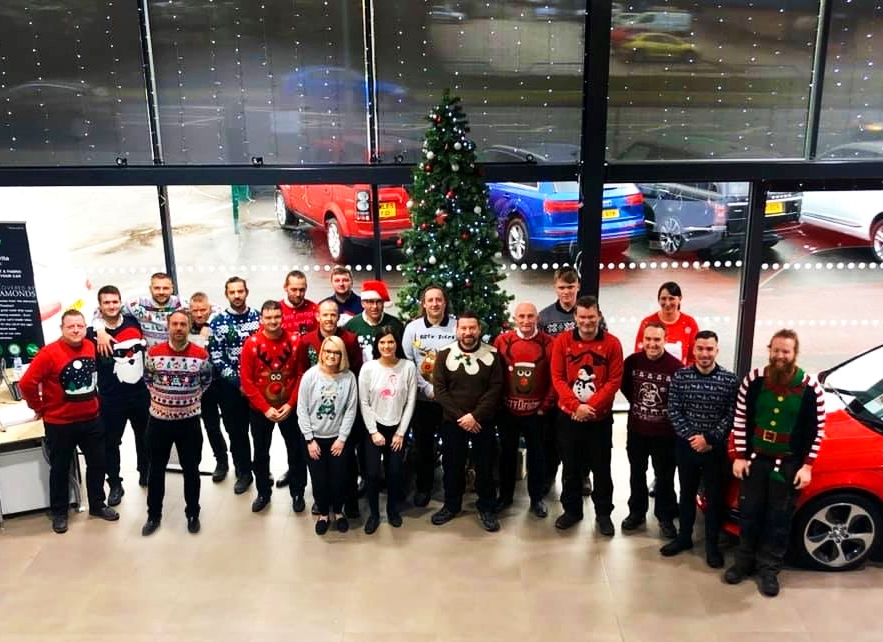 All the staff standing infront of the christmas tree
