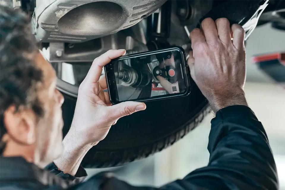 Land Rover Mechanic Inspecting Wheel