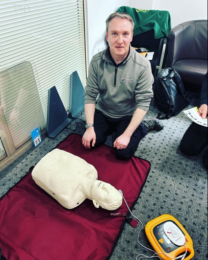 Man with cpr dummy