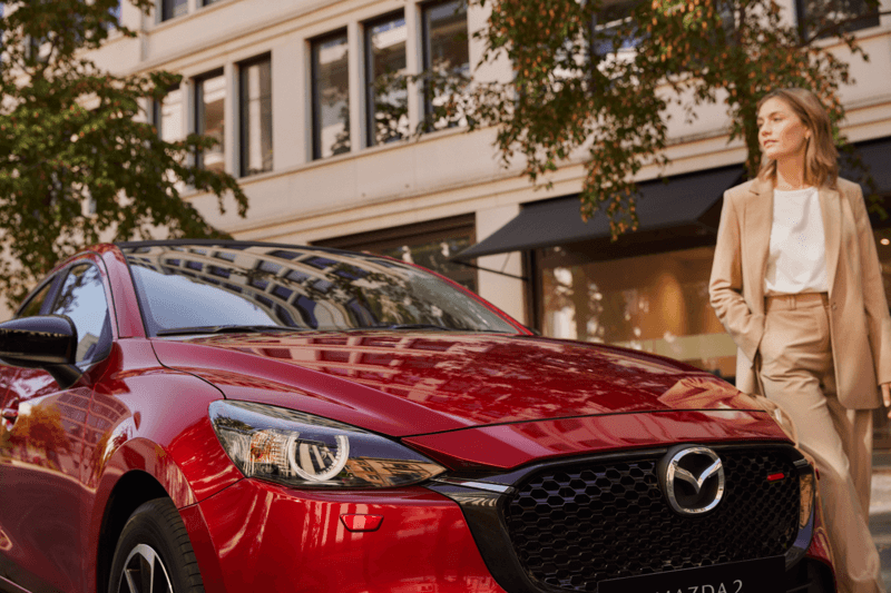 women by a mazda 2